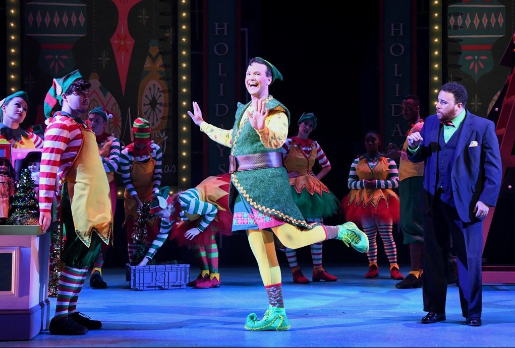 Buddy (David Schlumpf) helps the ensemble of ELF THE MUSICAL make Macy's Department Store more "Sparklejollytwinklejingley." (Photo: Stan Barouh)