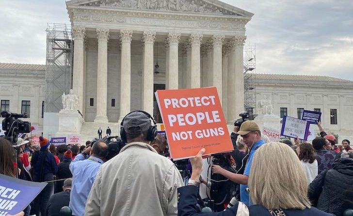 WASHINGTON - Participants in a rally outside the Supreme Court urge the justices to keep intact a federal law barring people involved in domestic abuse from owning a gun. (Josie Jack/Capital News Service)