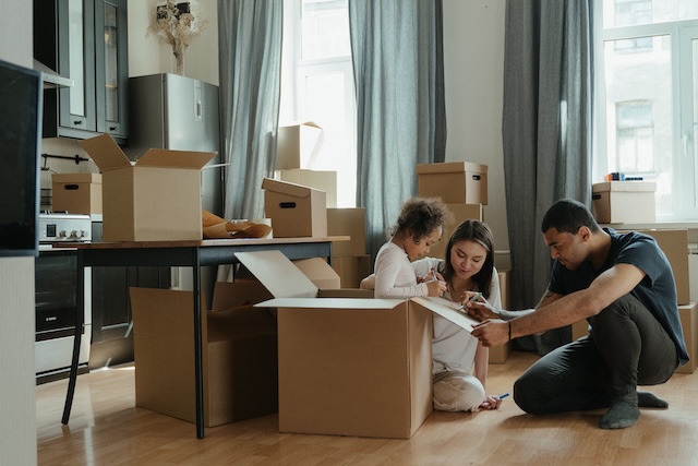 Family of three unpacking after moving to a new neighborhood in Rockville.